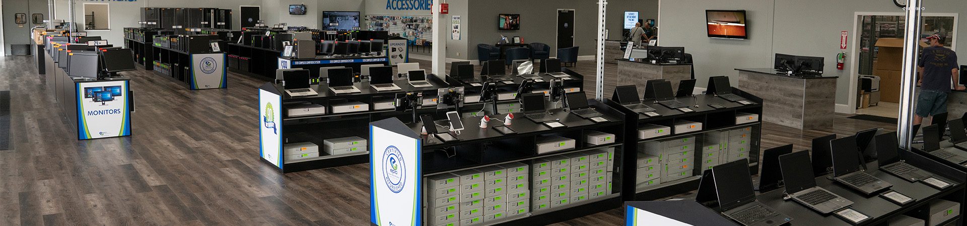 EPC St. Charles large, open retail electronics store featuring organized rows of laptops and computer equipment on modern display tables.